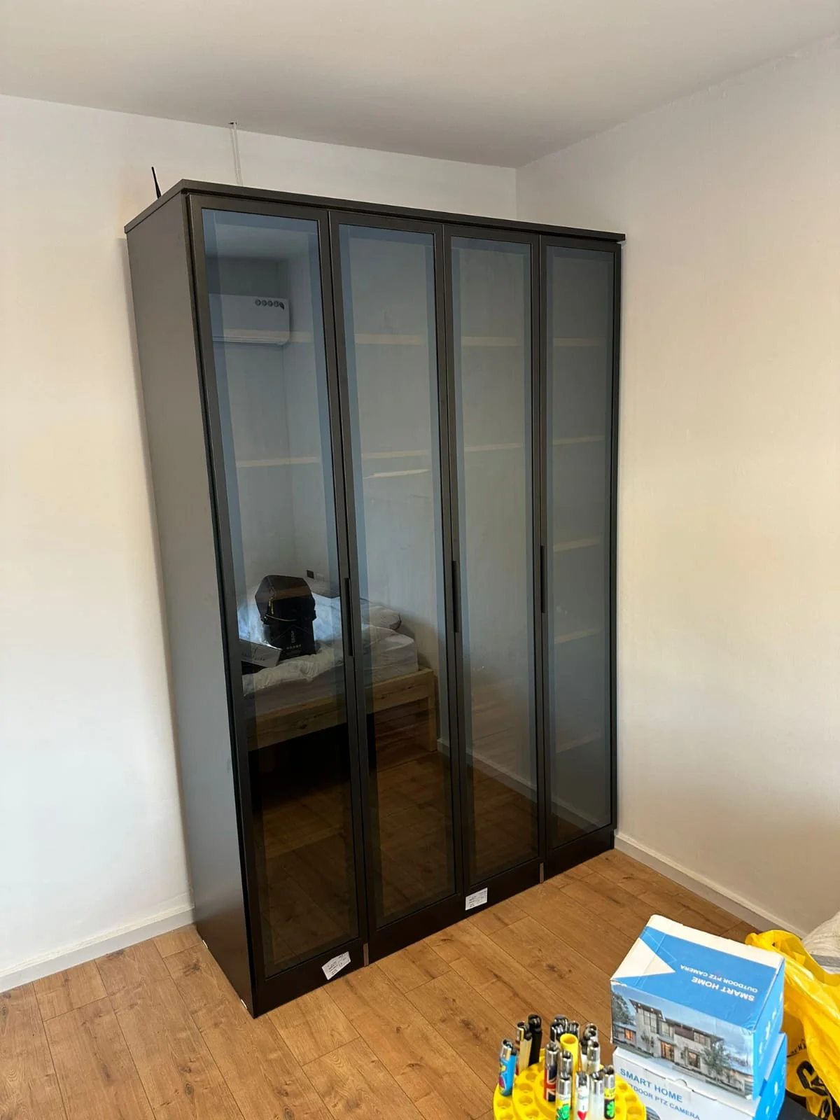 Installed wardrobe with dark glass doors in client home